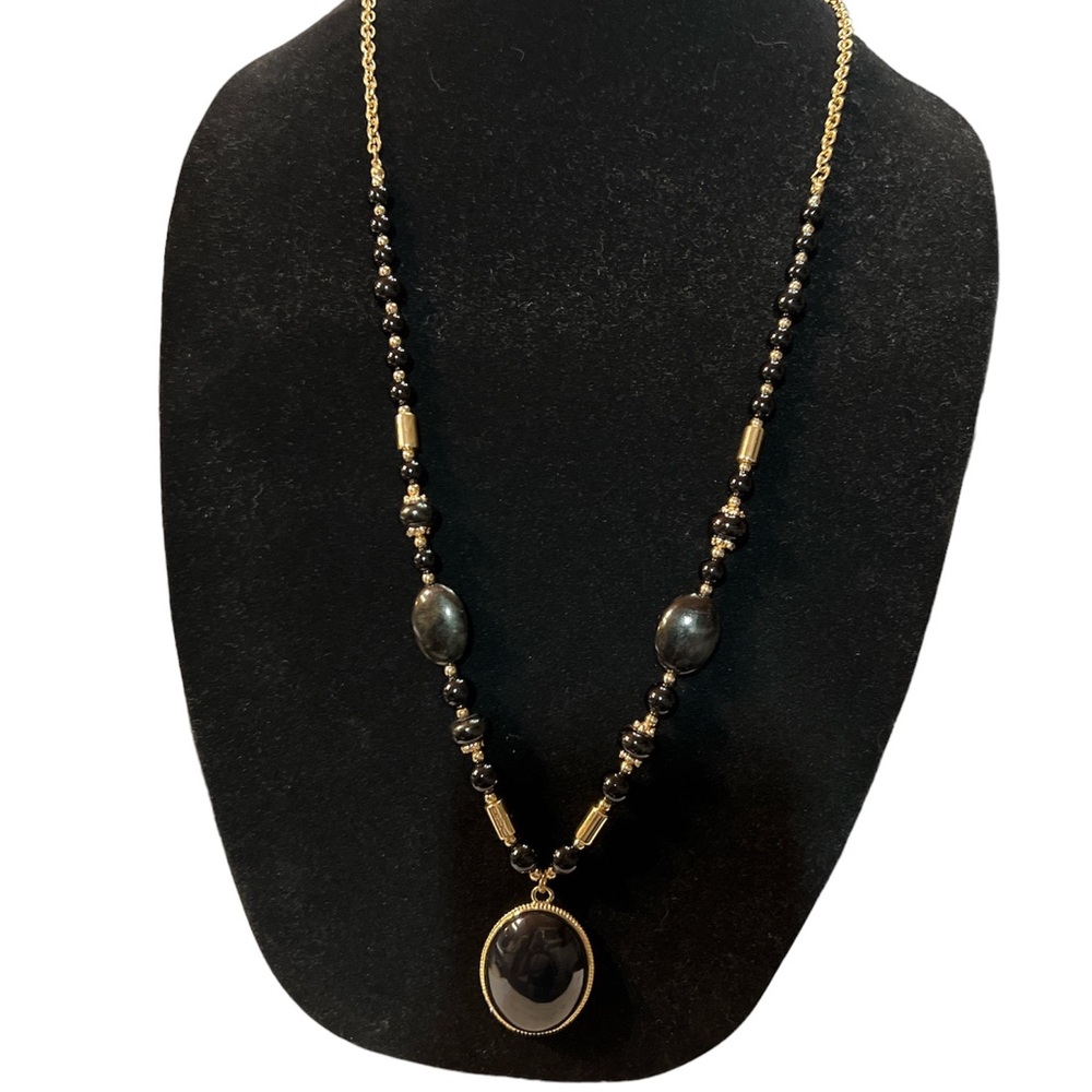 Gold and black beads on an 18” chain with black and gold medallion